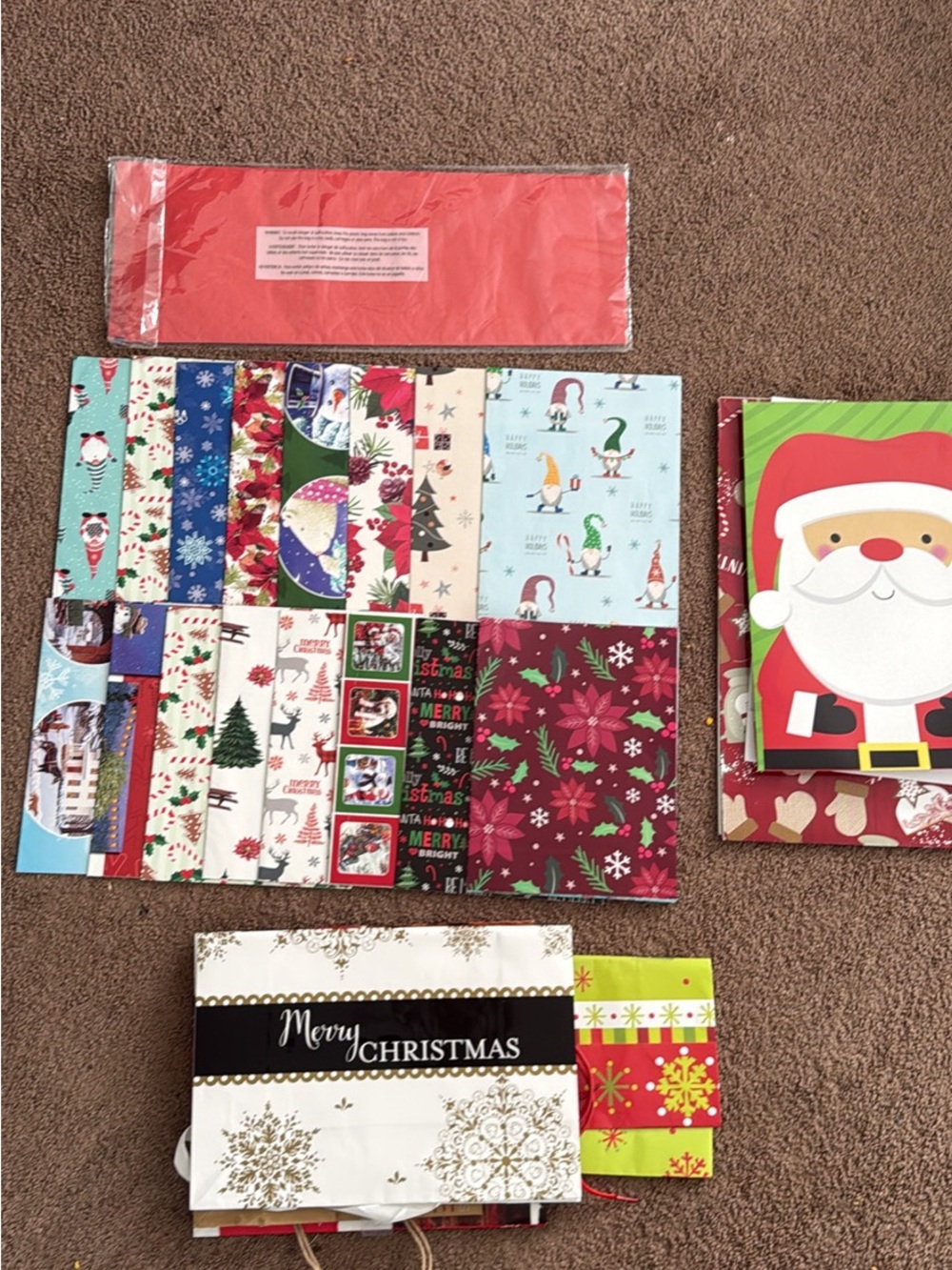 Assortment of Christmas gift bags, wrapped presents and tissue paper